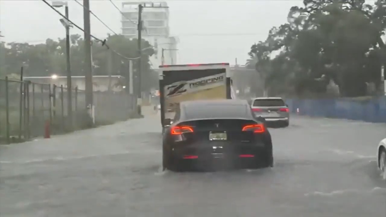 Imagen de WSVN 7News de una calle inundada en el Sur de la Florida con un Tesla negro en agua estancada