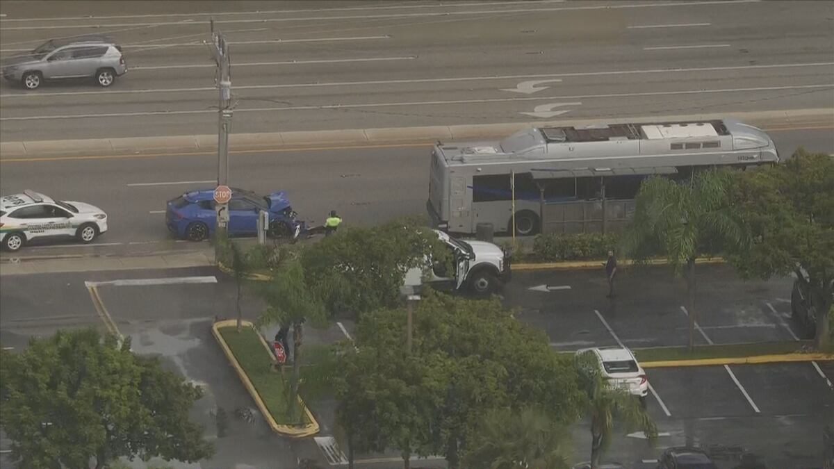 Local 10 Sky 10 aerial view of a Broward County Transit bus and a blue hatchback with front-end damage at Rock Island Road and West Commercial Boulevard in Tamarac.